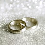 Two wedding rings surrounded by glitter