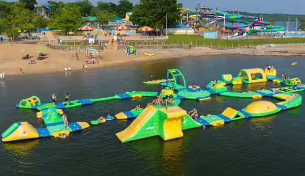 Dad and son splashing and playing in pool