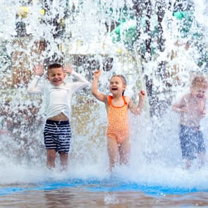 Kids getting splashed under the dump bucket