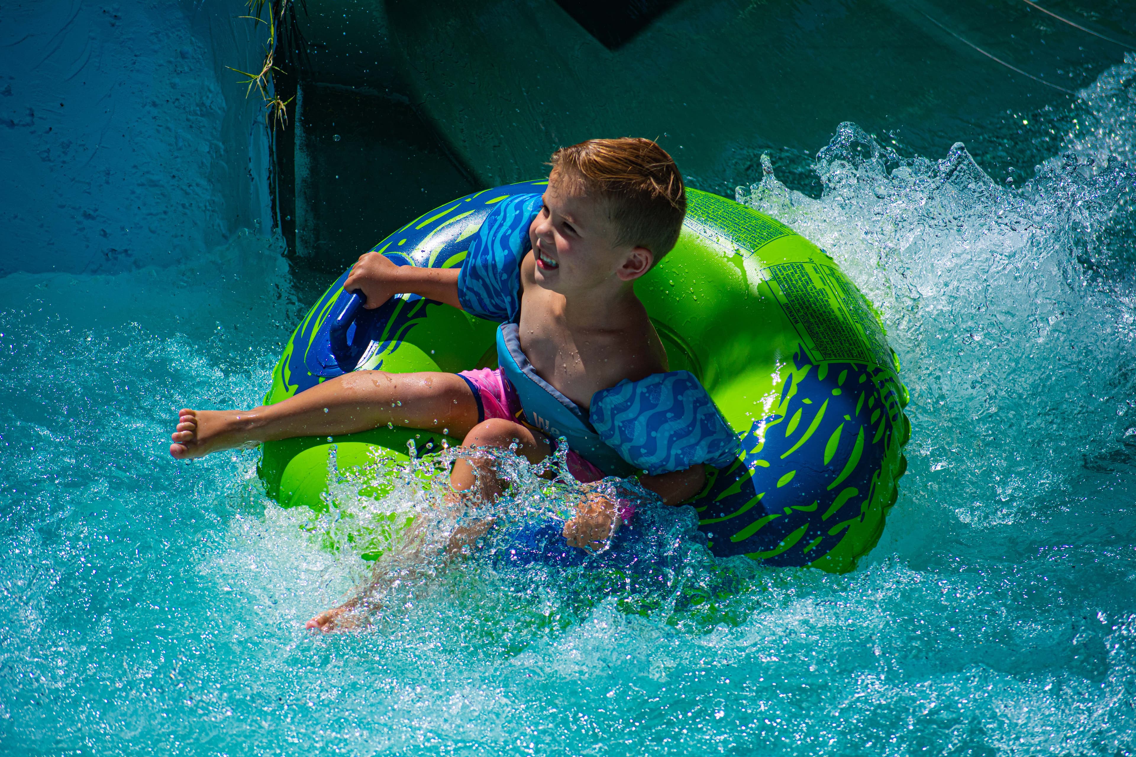 Child having fun on a water slide